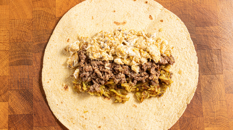 Tortilla filled with scrambled eggs, ground sausage and hash browns