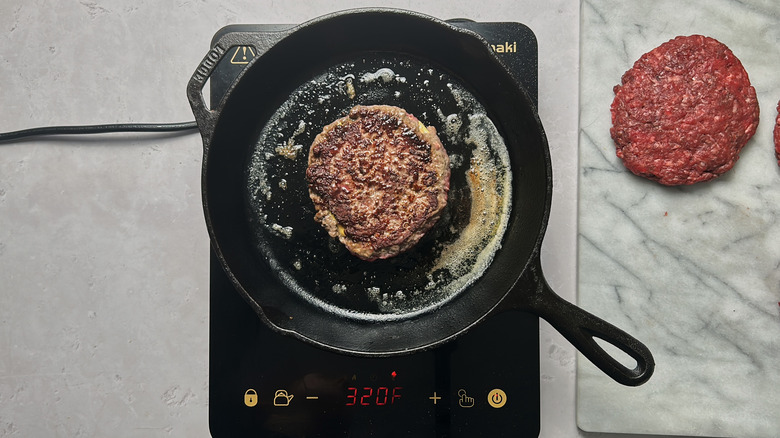 cooking hamburger in skillet