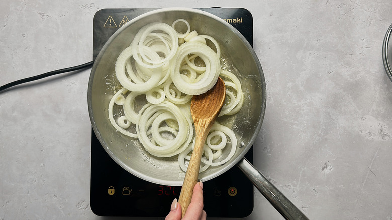 stirring onions in skillet