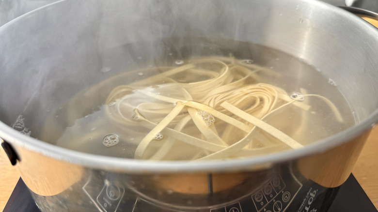 Fettuccine pasta cooking in boiling water