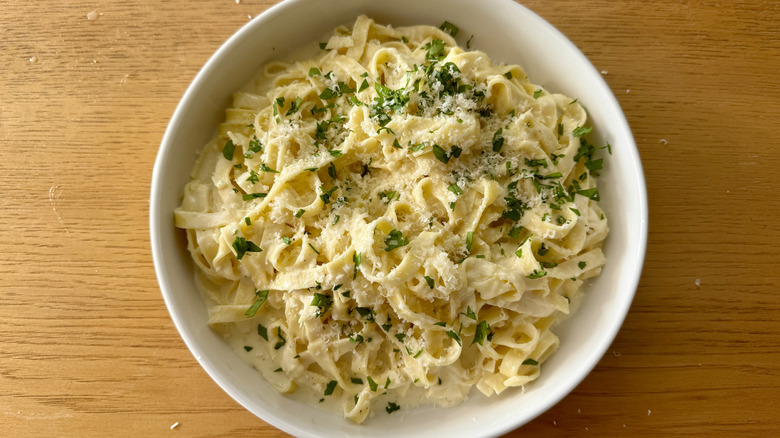 Fettuccine Alfredo with garnishes on plate