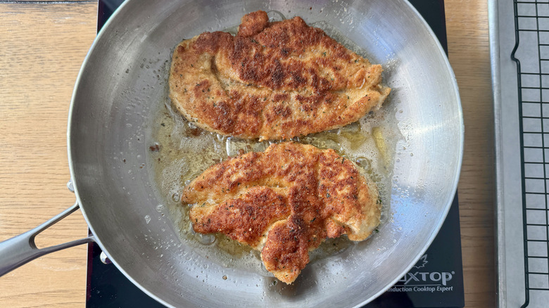 Breaded cooked chicken in skillet