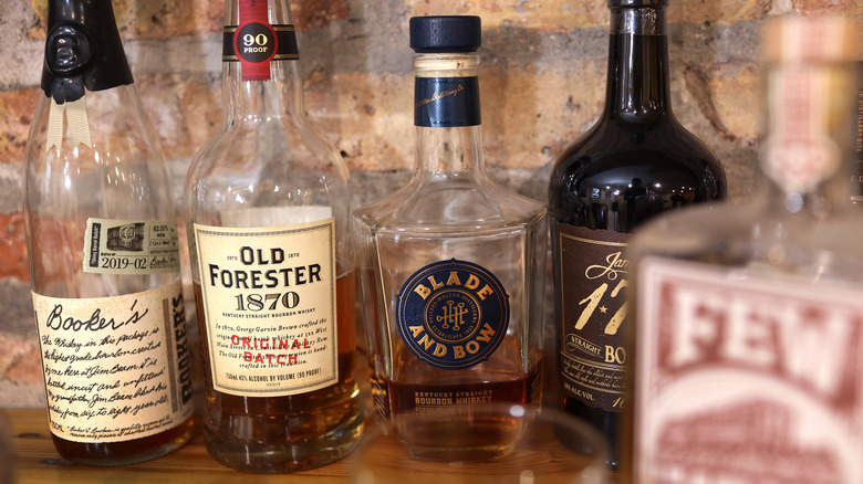 Various bottles of whiskey sitting on a table.