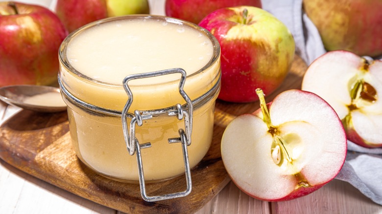 Applesauce in jar with apples