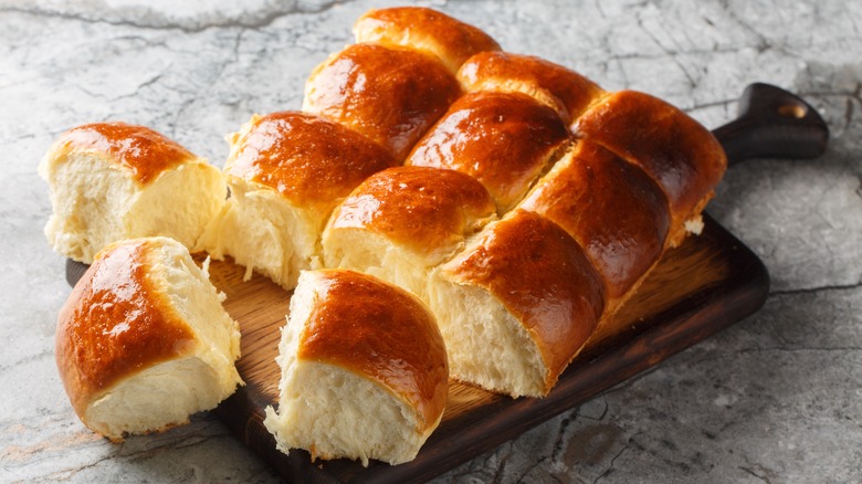 Golden brown dinner rolls with buttery glaze