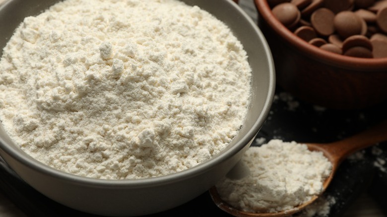 Bowl of flour next to chocolate chips