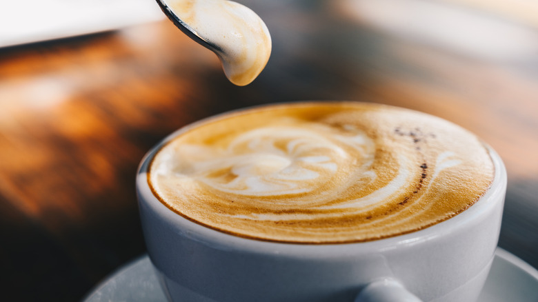 A coffee latte with milk foam latte art