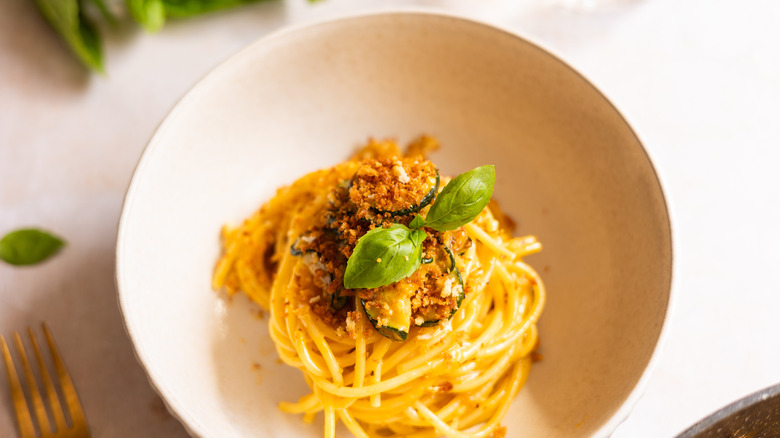 pasta in bowl with basil sprig 