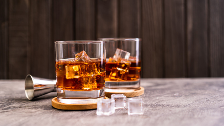 bourbon in glasses with ice cubes