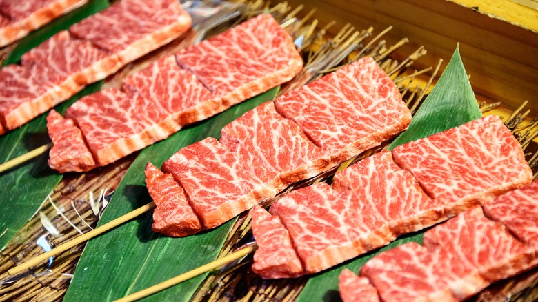 Wagyu beef slices on skewers