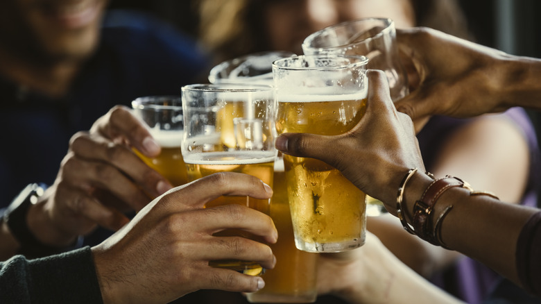 group of people cheersing glasses of beer