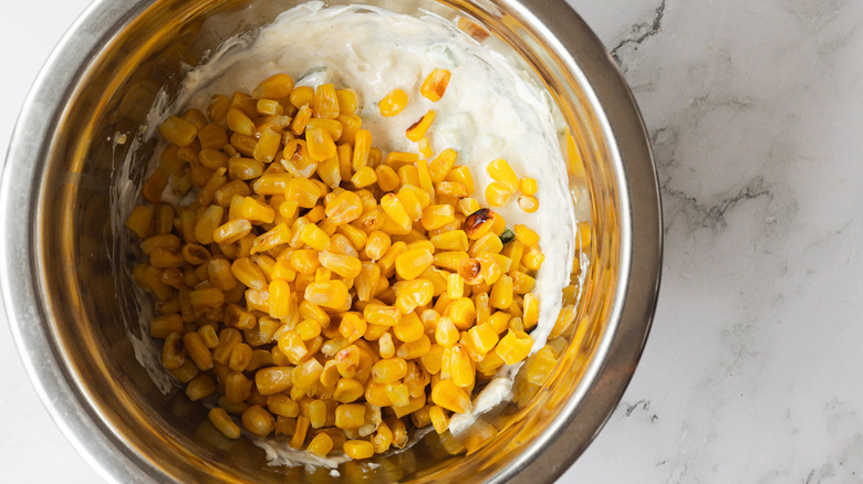 Corn added to dip in bowl