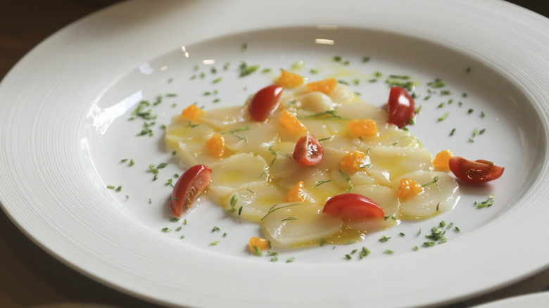 Scallop crudo on a plate