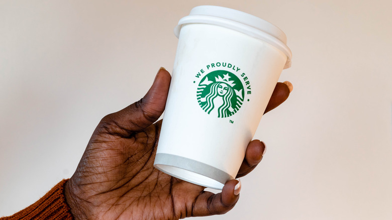 We Proudly Serve white cup