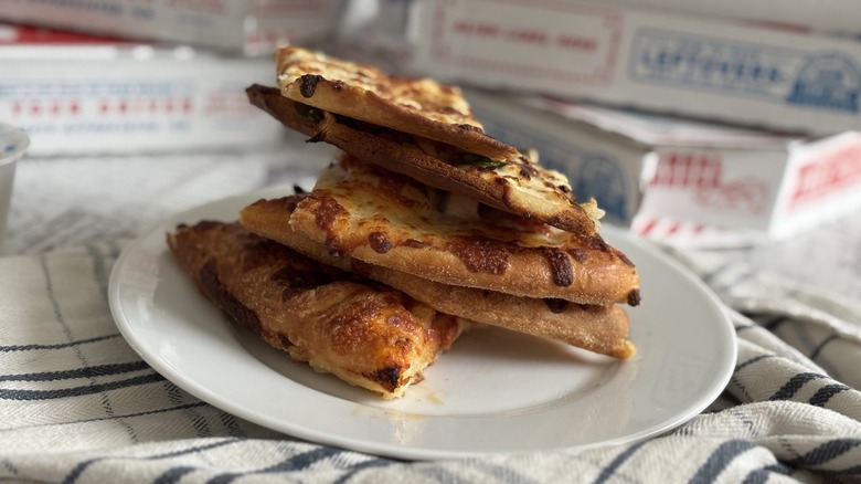 various Domino's pizza crusts in a pile