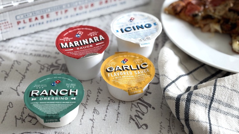 Domino's dipping sauce cups: ranch, marinara, garlic, and sweet icing