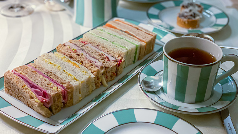 Variety of tea sandwiches with tea