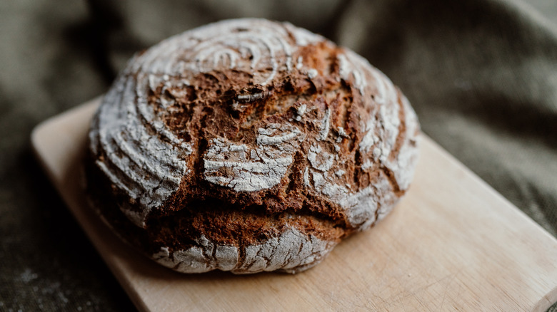 Loaf of bread on a wooden board.