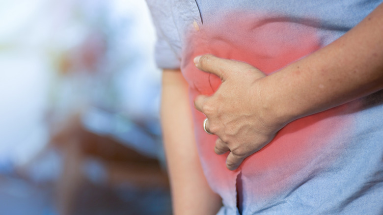 Man holding stomach in pain