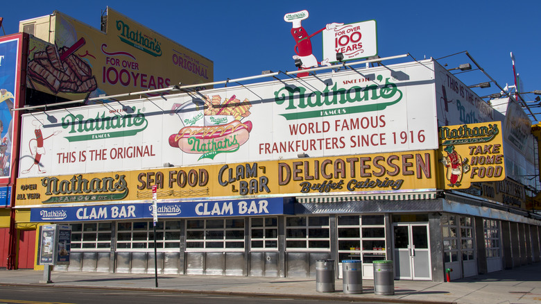 The exterior of a Nathan's Famous hot dog restaurant