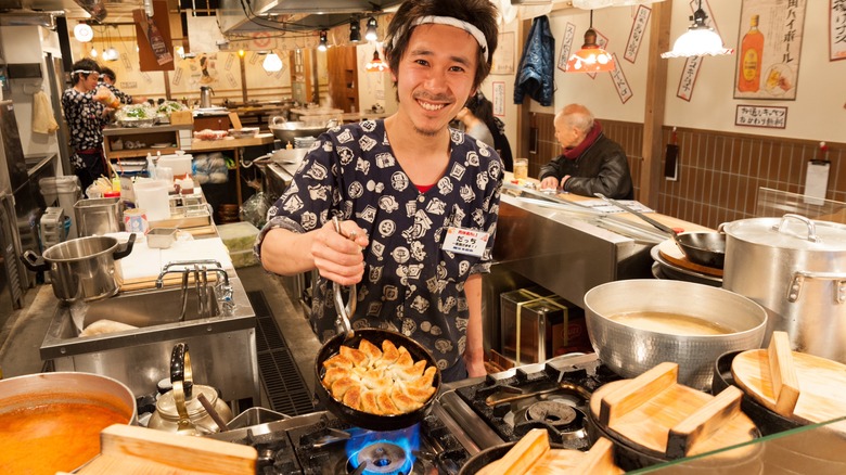 Restaurant cook making gyoza