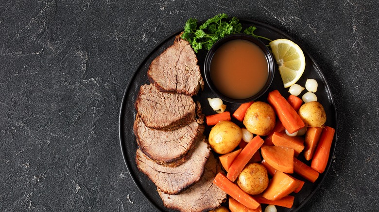 Roast beef and carrots with potatoes and white pearl onions