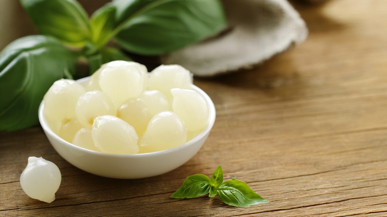 Pickled pearl onions in a white bowl