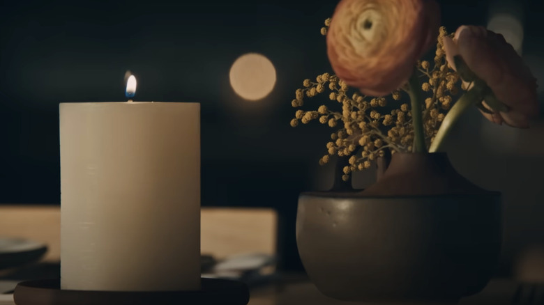 Candle and floral arrangement on a dining table in The Bear Season 3 trailer