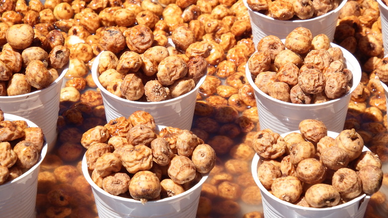 Tiger nuts grouped in full white plastic cups