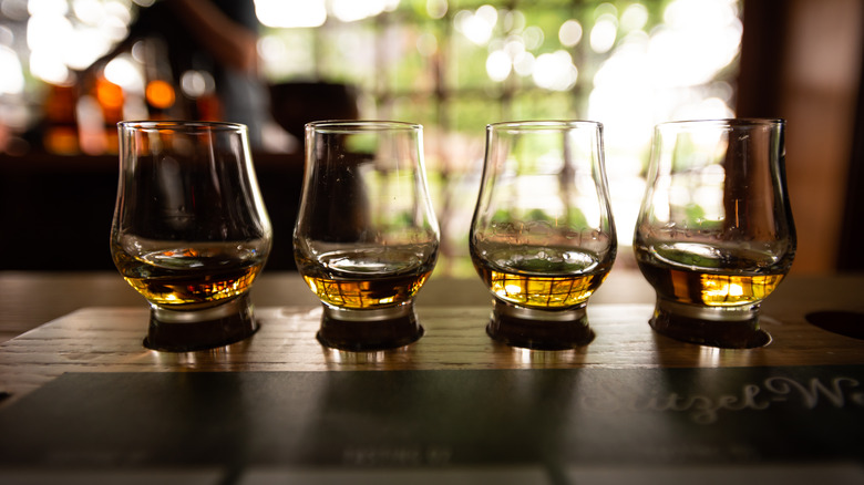 A bourbon flight containing four tasting glasses