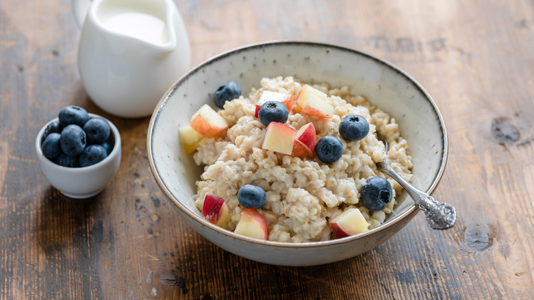 Bowl of oatmeal with fruit and milk