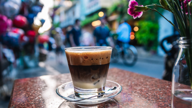 A cup of Vietnamese coffee on a street cafe table