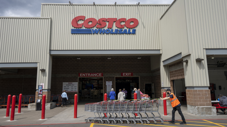 Costco warehouse with members and employees outside.