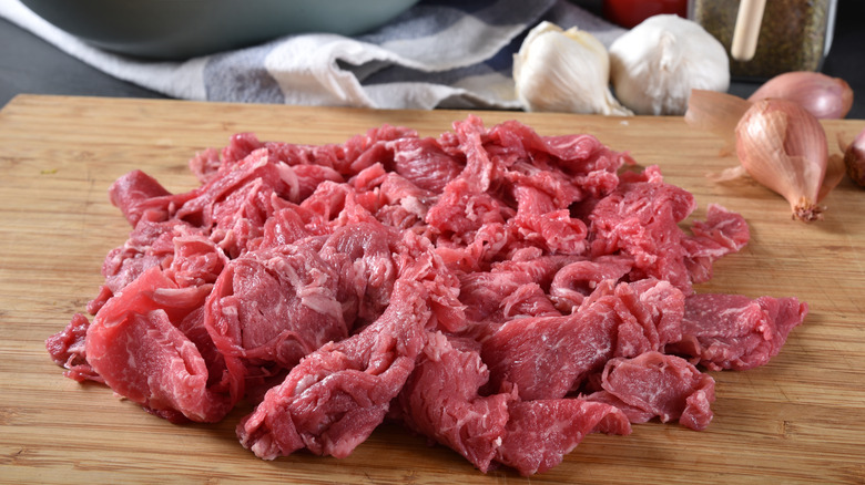 shaved steak served on cutting board