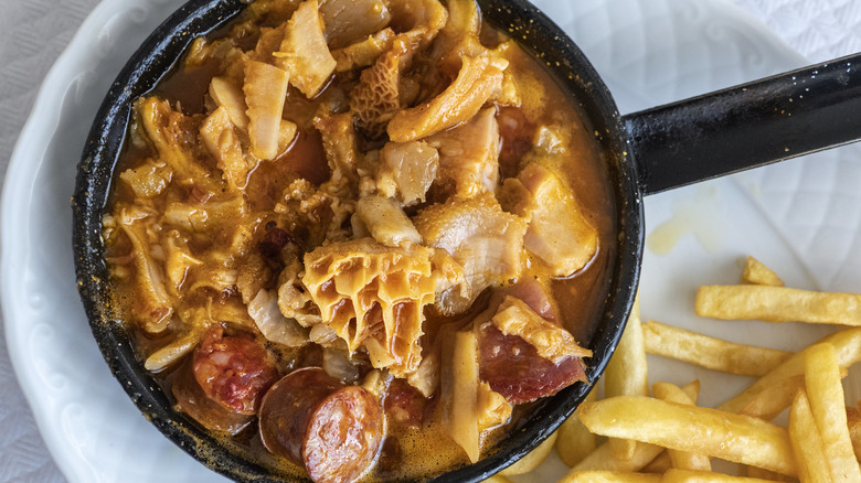 Tripe stew with sausage and French fries on the side