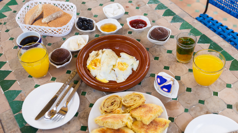 A Moroccan breakfast spread with eggs and pancakes.