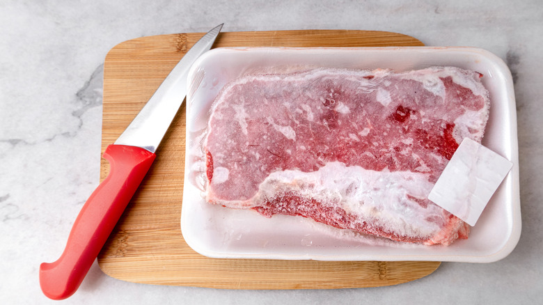 knife and frozen steak