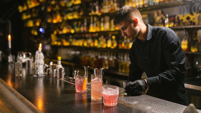 Bartender reaching for the speed rail