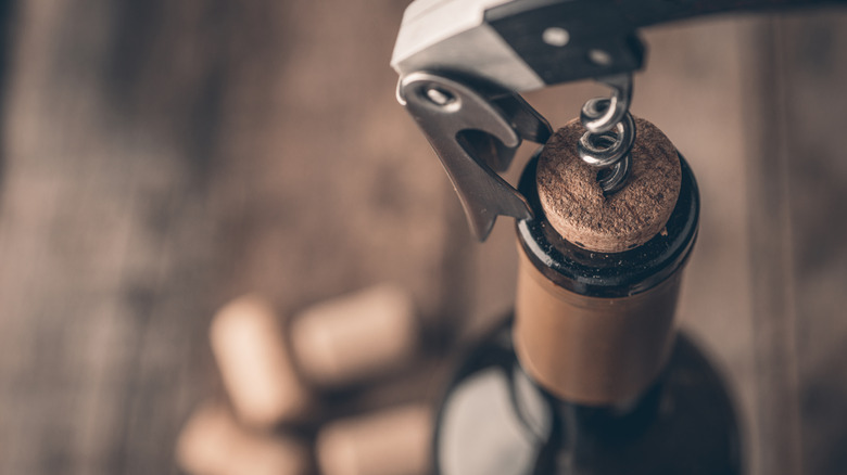 Corkscrew opening wine bottle