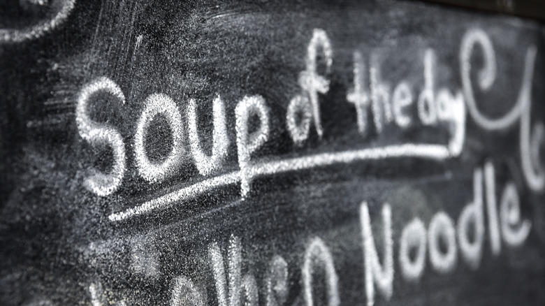 The phrase Soup of the Day written in chalk on a blackboard