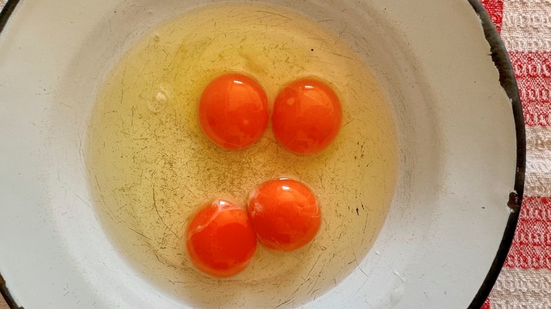 Red-orange egg yolks in a bowl