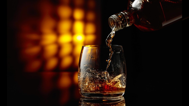 Pouring whiskey into a glass