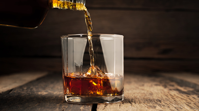 whiskey being poured into a glass