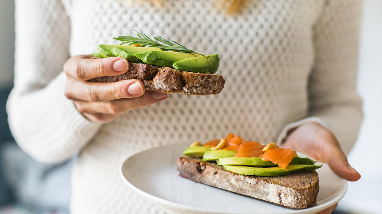 Person eating avocado toast