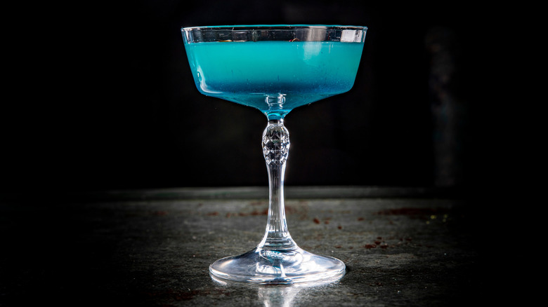 A blue lagoon cocktail on a black background.