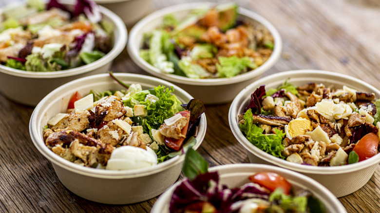 Chicken salads served in takeaway bowls