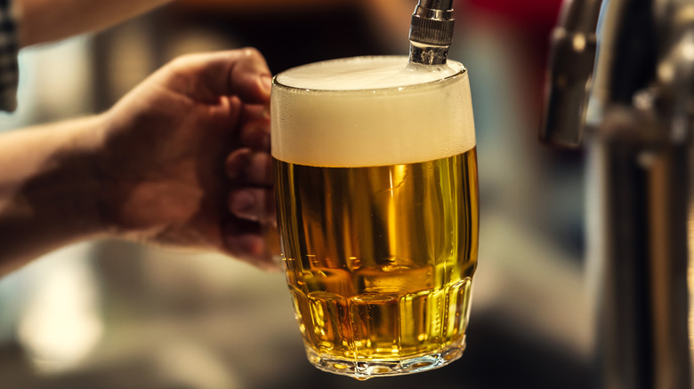 A bartender pouring beer into a glass