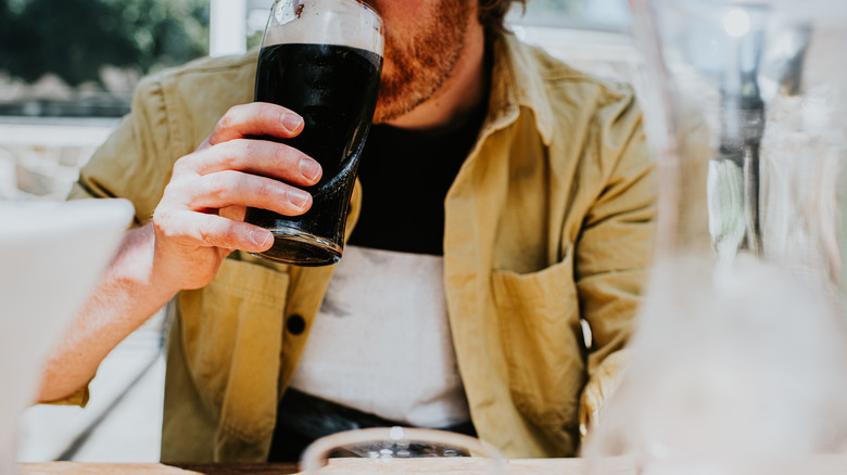 Man sipping dark porter beer