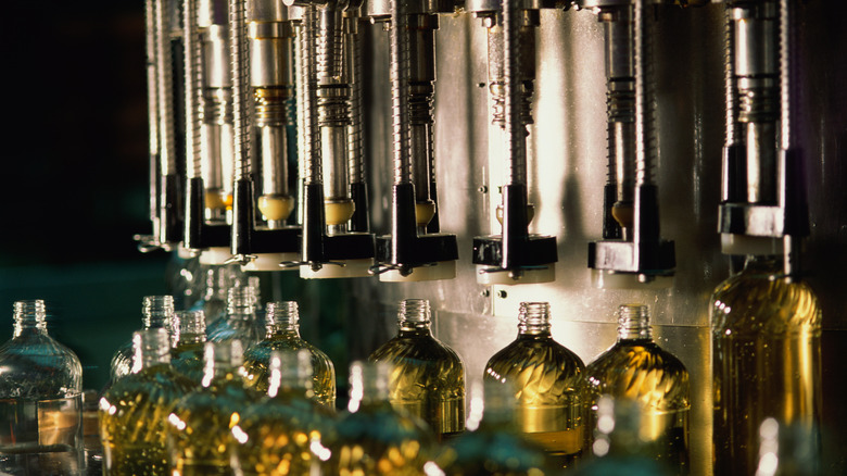 oil being bottled by large machine