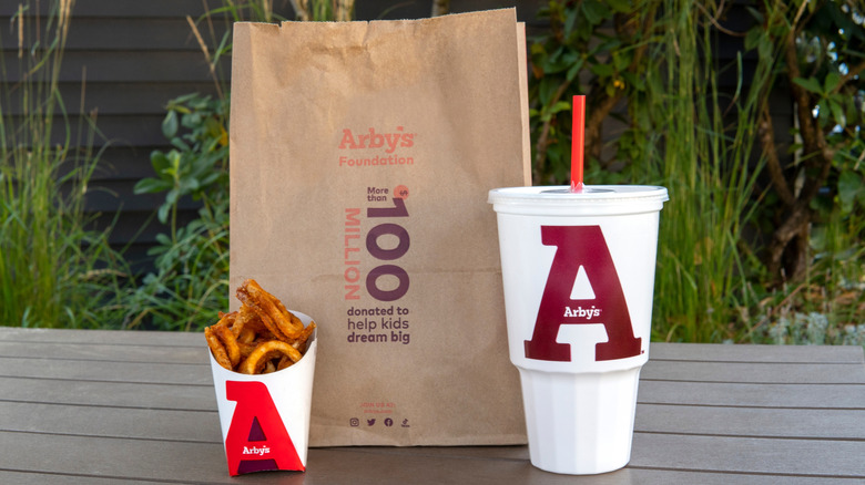 Arby's bag next to fries and a drink
